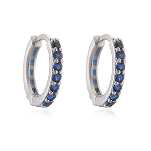 Close-up of silver hoop earrings with deep blue zircons and spring clasp detail