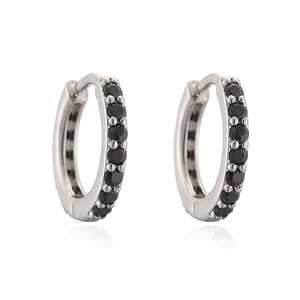 Macro view of polished silver hoop earrings featuring micro-paved black zircon stones