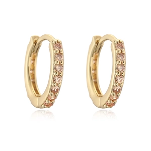 Detail view of 18k gold plated huggie earrings with champagne pave-set zircons