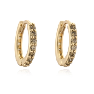 Detail of 12mm gold huggie earrings featuring round champagne cubic zirconia inlay