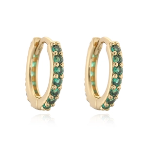 Close-up of gold hoop earrings with pavé-set green gemstones on a white background