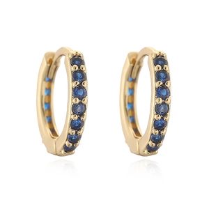 Macro view of gold hoop earrings with vertical row of deep blue round zircons