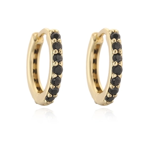 Macro detail of gold hoop earrings with row of micro-paved black zircon gemstones