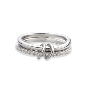 Macro shot of interlocking silver rings with polished metal band and pavé cubic zirconia stones