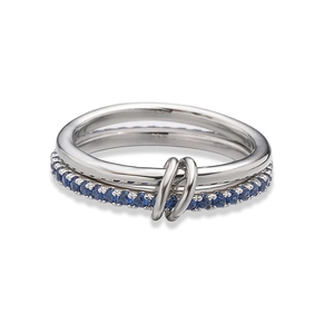 Detail of interlocking silver rings with pave-set blue sapphire zircons and polished finish