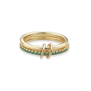 Close-up of interlocking gold rings with pave-set green crystals for layered look