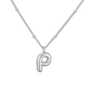 Dettaglio macro del ciondolo a lettera P a bolla d'argento su collana a sfere