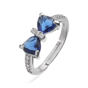 Detailed macro view of luxury bow ring with blue gemstones and sparkling small diamonds