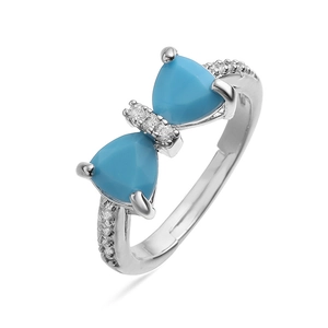 Macro detail of silver bow ring with blue triangle gemstones and pavé zircon stones