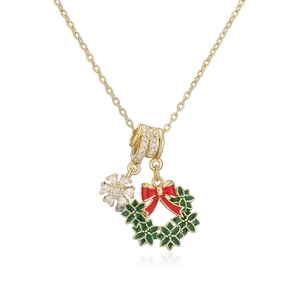 Collier de Noël avec couronne en émail vert et nœud rouge sur une chaîne dorée