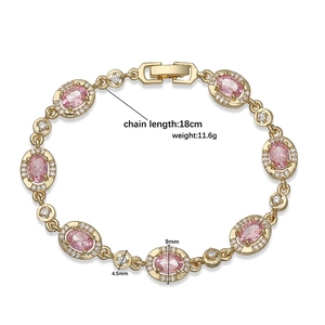 Vintage golden bracelet with oval pink crystals and white pavé diamonds on a white backdrop