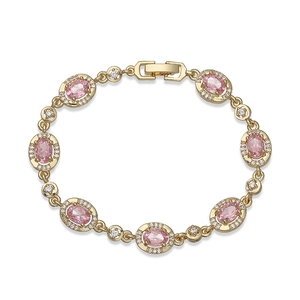 Detail of vintage gold bracelet with oval pink gemstones and white diamond halo settings