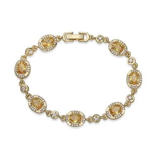 Detail of vintage gold bracelet featuring oval yellow crystals and micro-pave accents