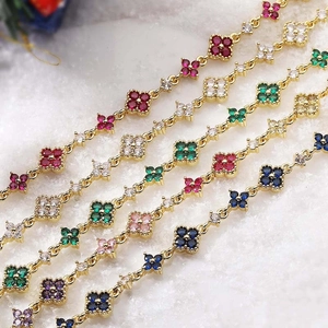 Luxurious gold bracelet featuring colorful clover charms with inlaid cubic zirconia stones