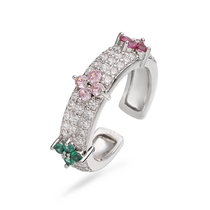Detailed macro view of adjustable silver clover ring with pink and purple crystals
