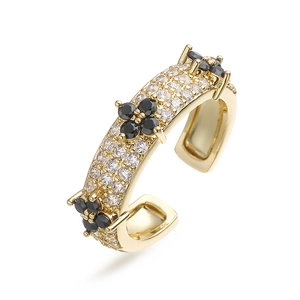 Detailed macro of gold plated clover ring featuring pavé set white zirconias