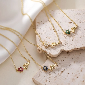 Detailed view of floral necklaces with colorful zirconia petals in red, blue, green and white