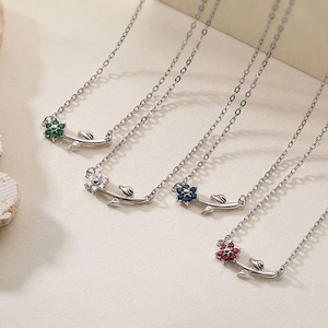Macro shot of colorful camellia necklaces with green, white, blue and red crystal petals