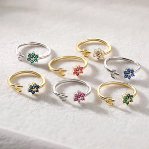 Detail of adjustable flower rings with colorful zirconia stones in gold and silver plating