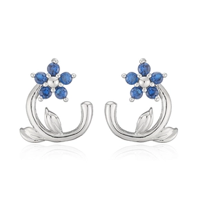 Detailed view of silver camellia stud earrings with sparkling blue zircon petals