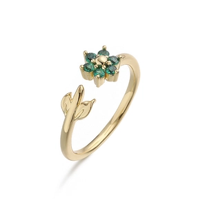 Macro view of gold adjustable ring featuring green stone flower and delicate gold leaf detail
