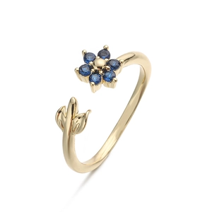 Detail of adjustable gold ring with blue sapphire flower and delicate leaf elements