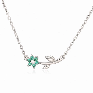 Detailed silver necklace featuring a green stone camellia pendant and leaf accent
