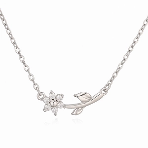 Macro detail of silver floral necklace with cubic zirconia petals and delicate O-chain