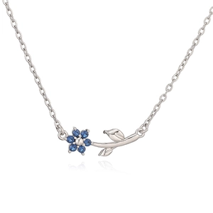 Detailed view of silver flower pendant necklace with six round blue cubic zirconia petals