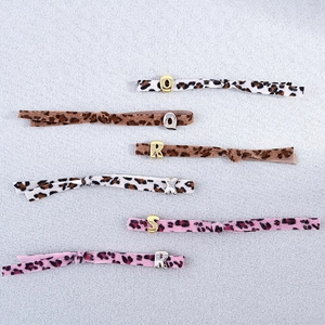 Elastic leopard print bracelet with metallic alphabet charms in assorted colors