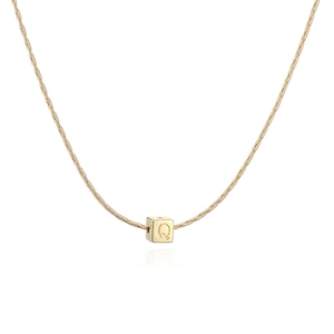 Vue macro d'un pendentif cube plaqué or 18K minimaliste avec lettre Q sur chaîne serpent