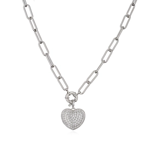 Close-up of heart-shaped silver pendant with micro-pave zircons on a paperclip chain