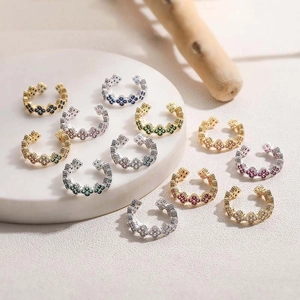 Luxurious clover rings with colorful zircons in gold and silver plating on marble tray