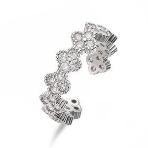 Macro detail of silver clover ring with sparkling zircon flowers and adjustable band