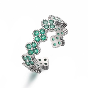 Detail of adjustable silver clover ring featuring sparkling green emerald stones