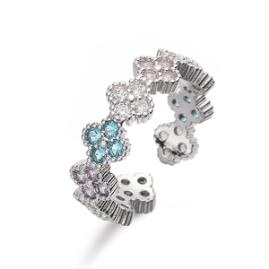 Macro detail of silver adjustable ring featuring colorful four-leaf clover petals