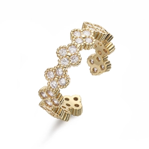 Detail of clover ring featuring white zircon pave setting and adjustable gold-plated band