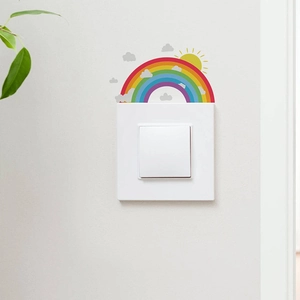 Detailed view of luminous rainbow and sun wall stickers around a light switch panel