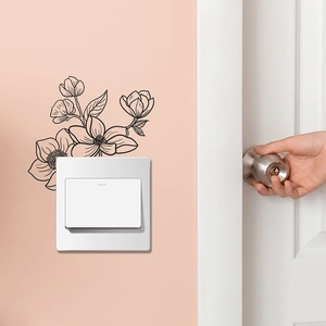 Black sketch floral wall sticker above light switch on warm pink bedroom wall