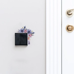 Détail de stickers muraux fleurs à l'aquarelle autour d'un interrupteur de maison