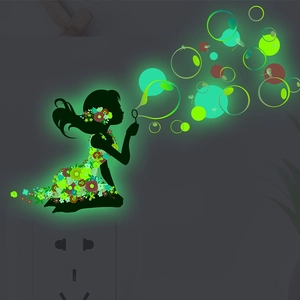 Luminous wall sticker showing a girl blowing bubbles with glowing floral dress on a wall