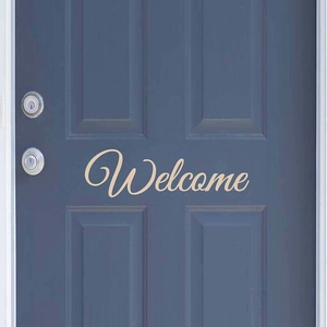 Elegant cursive Welcome wall sticker in cream white applied to a dark blue wooden door
