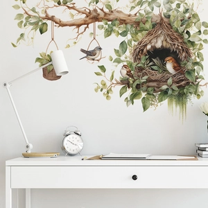Detail of watercolor bird and nest wall decal on a white wall in a modern room