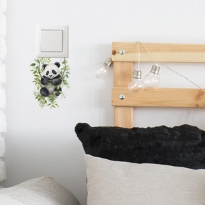 Detail of cute panda on vine wall sticker applied near light switch in bedroom decor