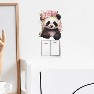 Close-up of cute panda wall sticker with rose crown decorated above a light switch
