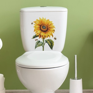 Detailed view of vibrant sunflower and bees self-adhesive wall stickers on a white toilet tank
