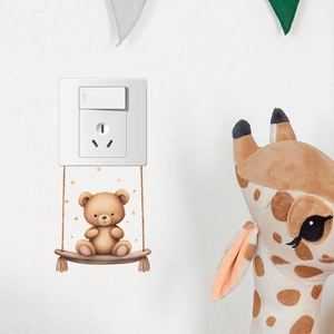 Cartoon brown bear on swing wall sticker for nursery switch decoration with gold stars