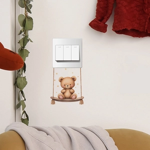 Detailed view of brown teddy bear on a swing wall sticker near light switch decoration