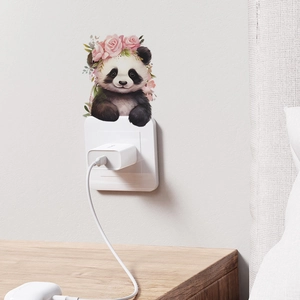 Cartoon panda with rose crown wall sticker decorating a white light switch in a bedroom