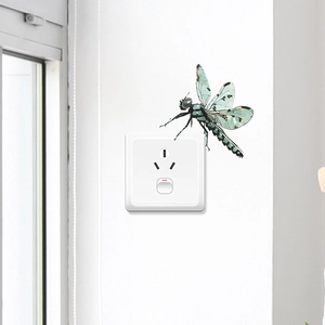 Cartoon green dragonfly decorative wall sticker for home switch in a minimalist setting
